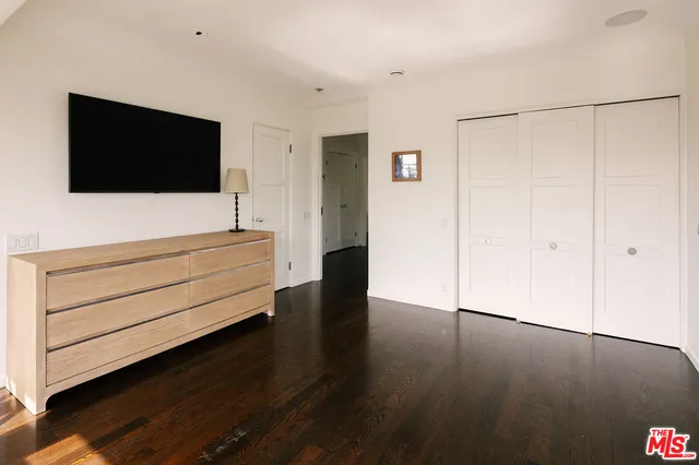 a view of room with hardwood floor and cabinet