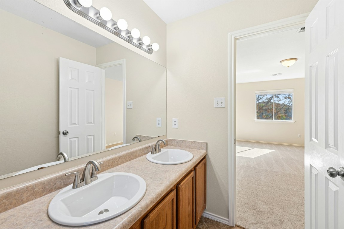 17913 Honey Locust Lane Elgin, TX 78621 - Photo 21 of 31 a bathroom with a sink double vanity and a mirror
