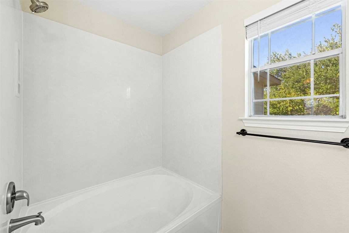 17913 Honey Locust Lane Elgin, TX 78621 - Photo 22 of 31 a white bath tub sitting next to a window