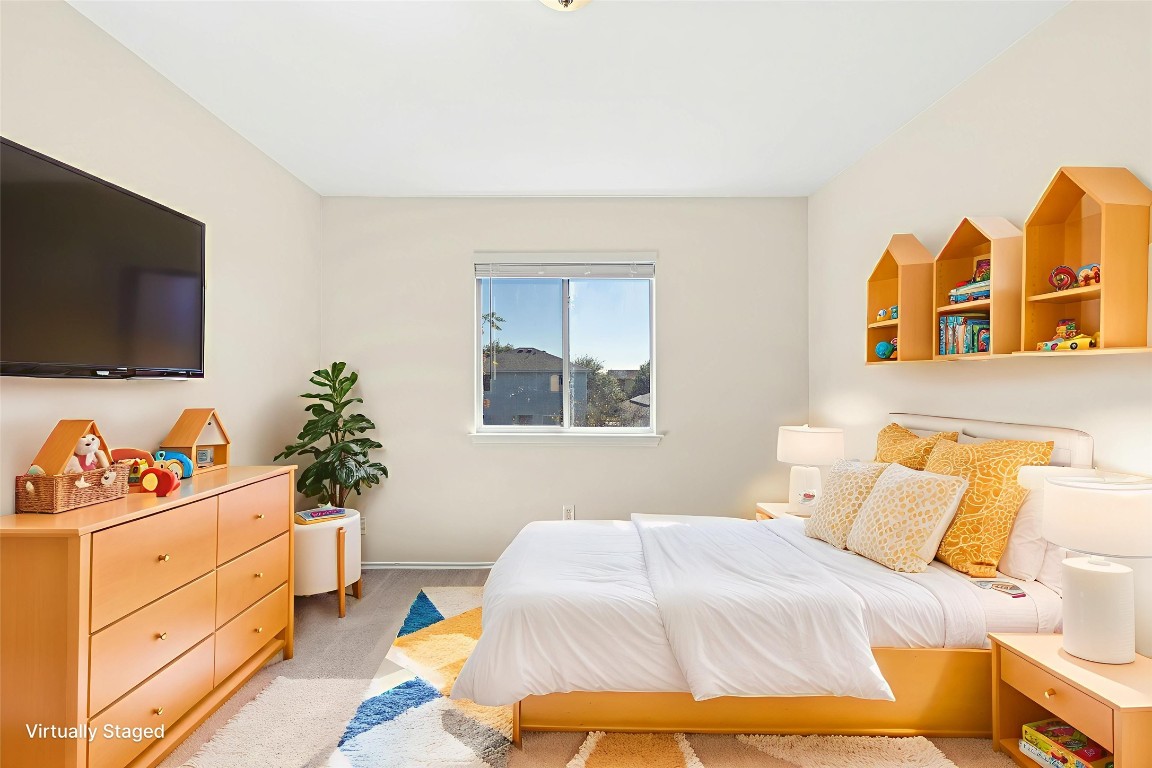 17913 Honey Locust Lane Elgin, TX 78621 - Photo 23 of 31 a bedroom with a bed and a flat screen tv