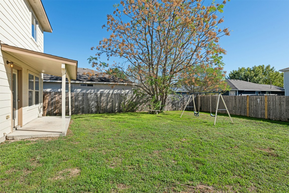 17913 Honey Locust Lane Elgin, TX 78621 - Photo 29 of 31 a view of a backyard with wooden fence and large trees