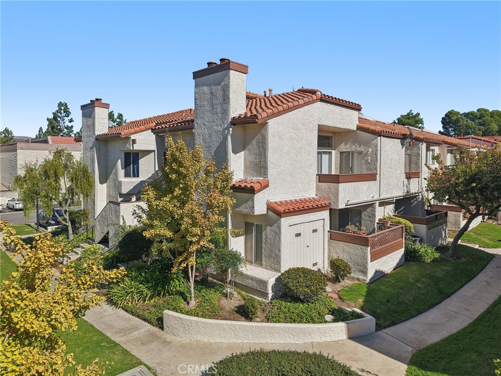 a front view of a house with a yard and fountain