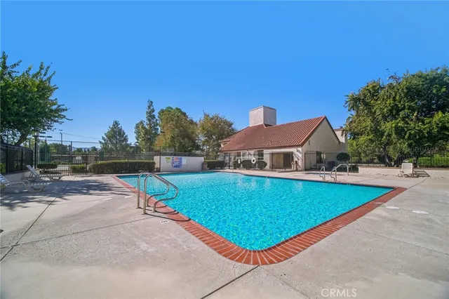 a view of a swimming pool with a yard