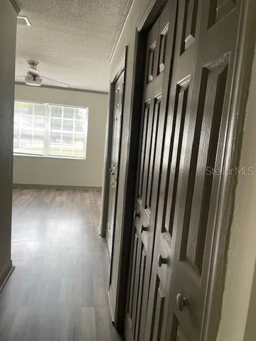 a view of a room with wooden floor and windows