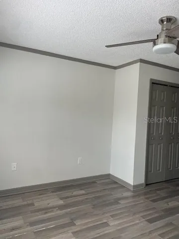 a view of a room with wooden floor