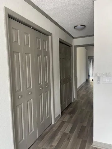 a view of a hallway with wooden floor