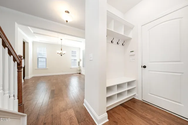 a view of a hallway with wooden floor and closet