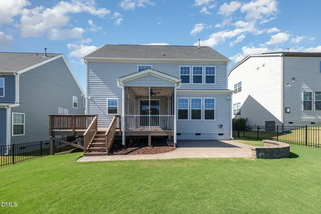 a view of a house with backyard porch and sitting area