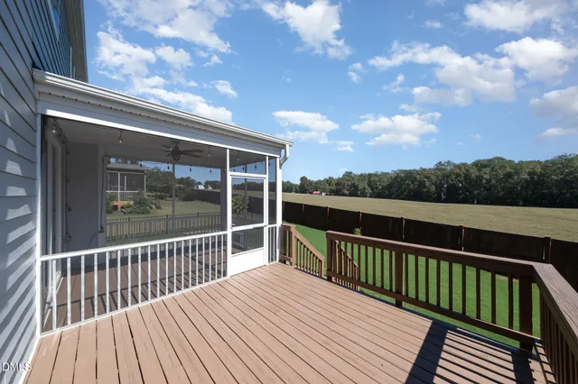 a view of balcony with wooden floor and fence