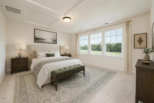 a bedroom with a bed a couch and large window