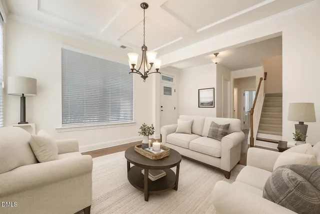 a living room with furniture and a chandelier