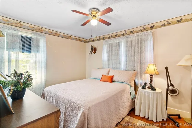 a bedroom with a bed and a potted plant