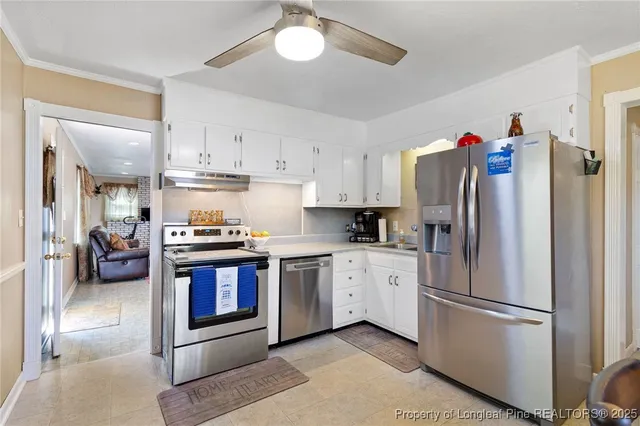 a kitchen with stainless steel appliances granite countertop a refrigerator a stove and a sink