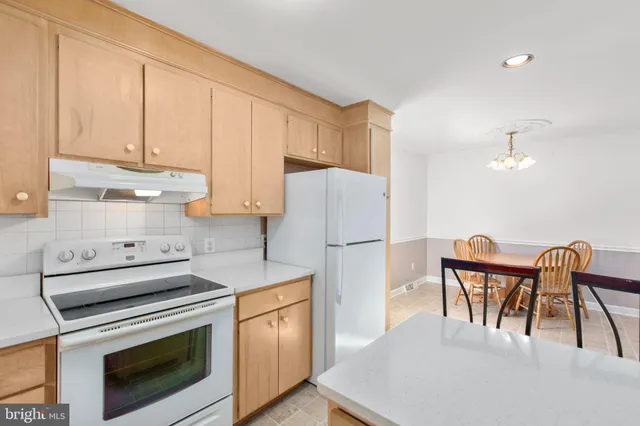 a kitchen with appliances cabinets and wooden floor