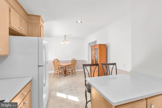 a view of a dining room with furniture and a chandelier