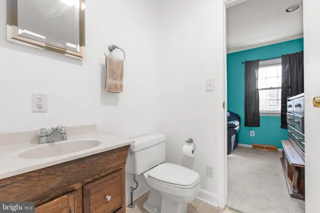 a bathroom with a sink toilet and mirror