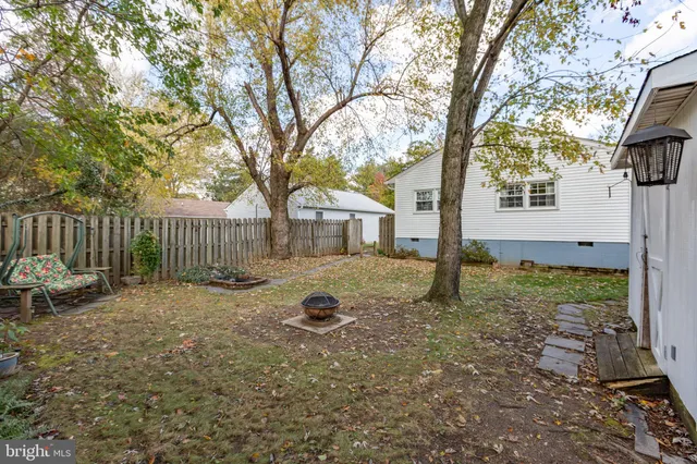 a view of a backyard with large trees