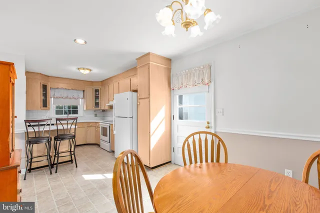 a view of a dining room with furniture and a chandelier