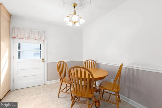 a view of a dining room with furniture and chandelier