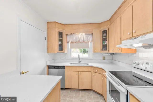 a kitchen with a sink stove and cabinets