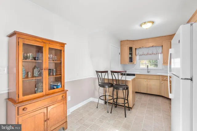 a dining room with a window and chairs