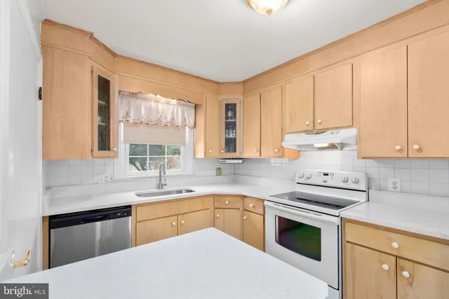 a kitchen with a sink stove and cabinets