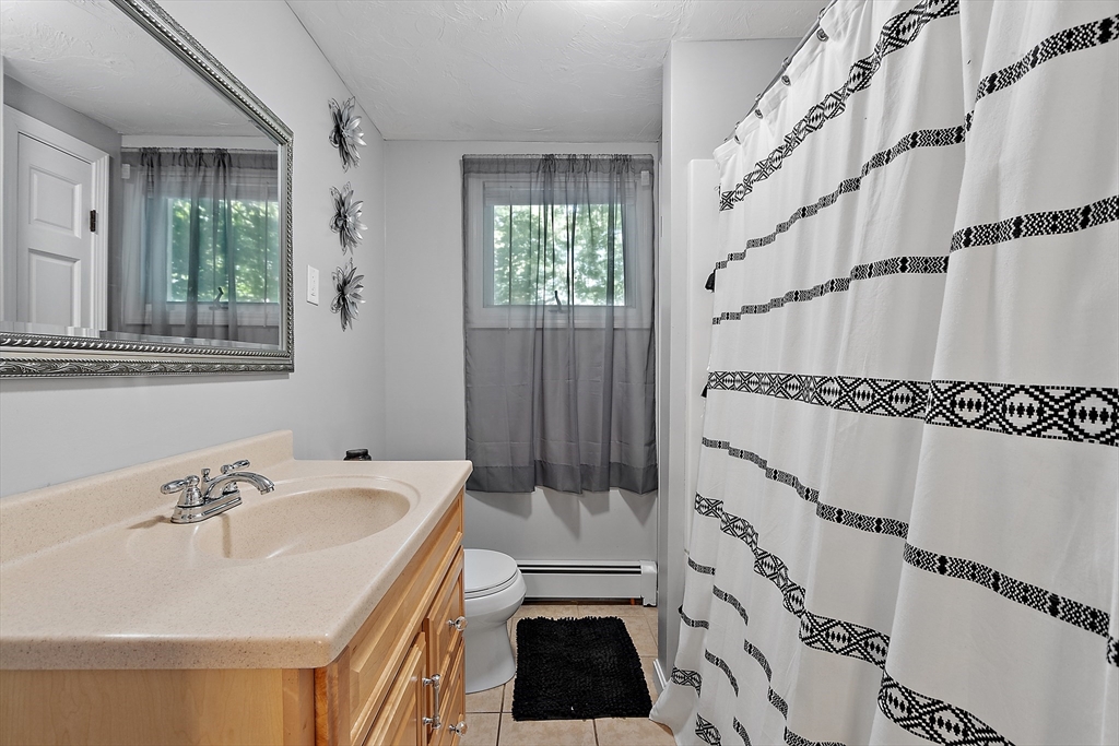506 Pleasant Street Gardner, MA 01440 - Photo 20 of 41 a bathroom with a sink a mirror and a shower