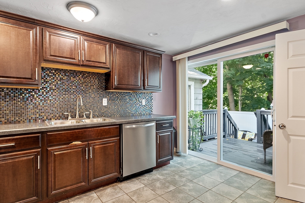 506 Pleasant Street Gardner, MA 01440 - Photo 23 of 41 a kitchen with granite countertop wooden cabinets a sink and a stove