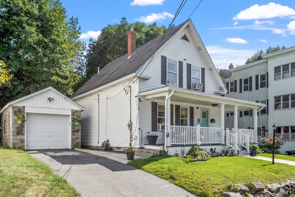 506 Pleasant Street Gardner, MA 01440 - Photo 3 of 41 a front view of a house with a yard and garage