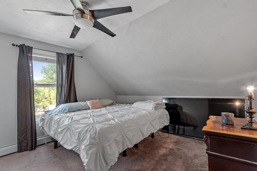 506 Pleasant Street Gardner, MA 01440 - Photo 33 of 41 a bed sitting in a bedroom next to a window