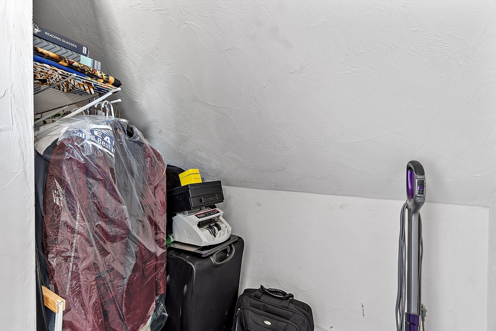 506 Pleasant Street Gardner, MA 01440 - Photo 35 of 41 a view of walk in closet with clothes and shoes