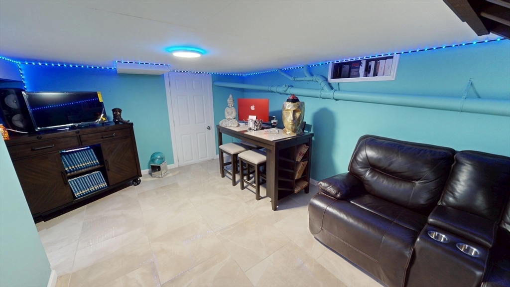 506 Pleasant Street Gardner, MA 01440 - Photo 40 of 41 a living room with furniture and a flat screen tv