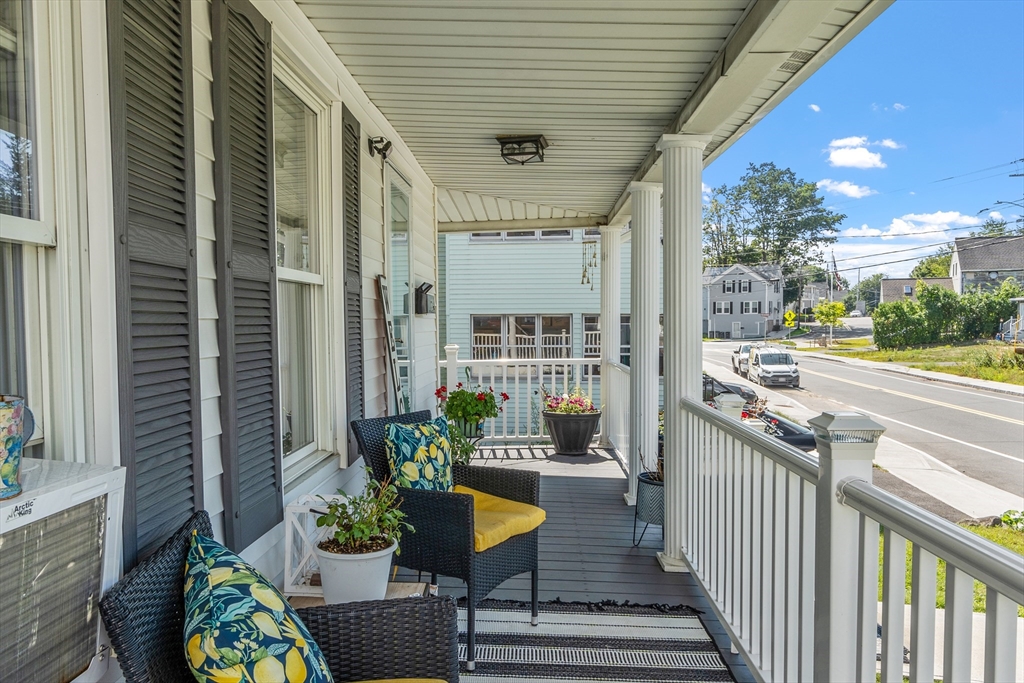 506 Pleasant Street Gardner, MA 01440 - Photo 4 of 41 a view of a balcony with chairs and potted plants