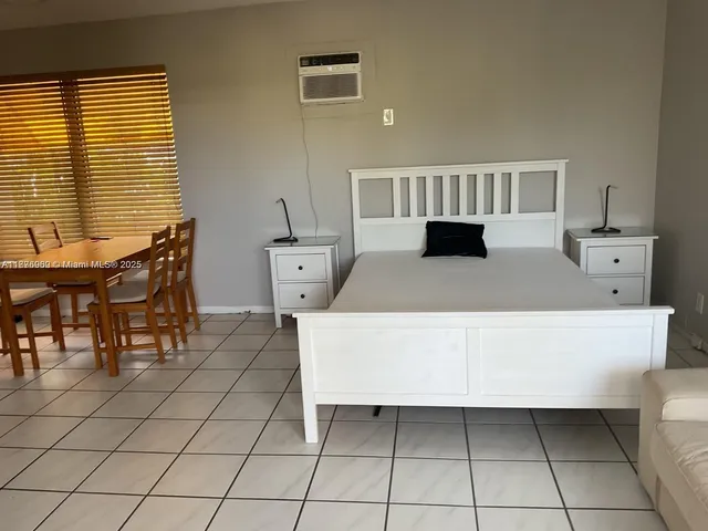 a living room with furniture a table and a window