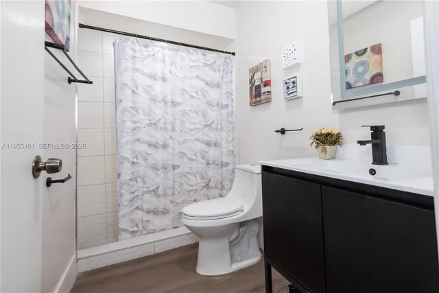 a bathroom with a sink toilet and shower