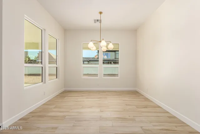 a kitchen with stainless steel appliances granite countertop a sink a stove and a wooden floors