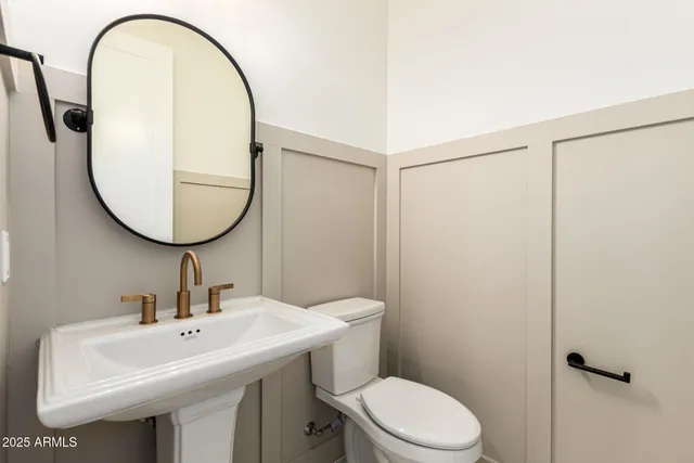 an empty room with wooden floor and a ceiling fan