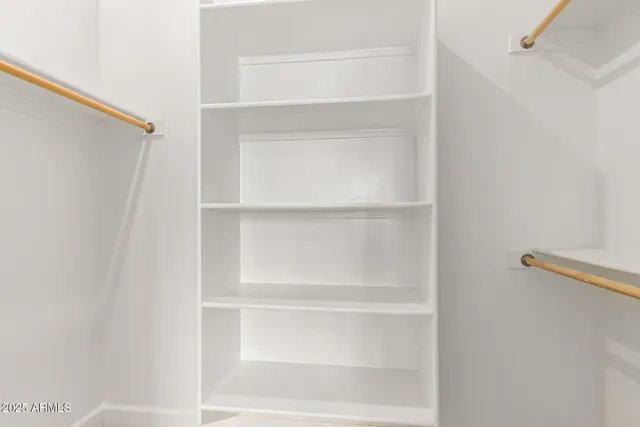 an empty room with fan and windows