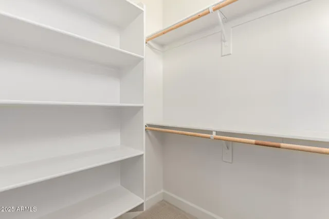 a view of a dry yard with wooden fence