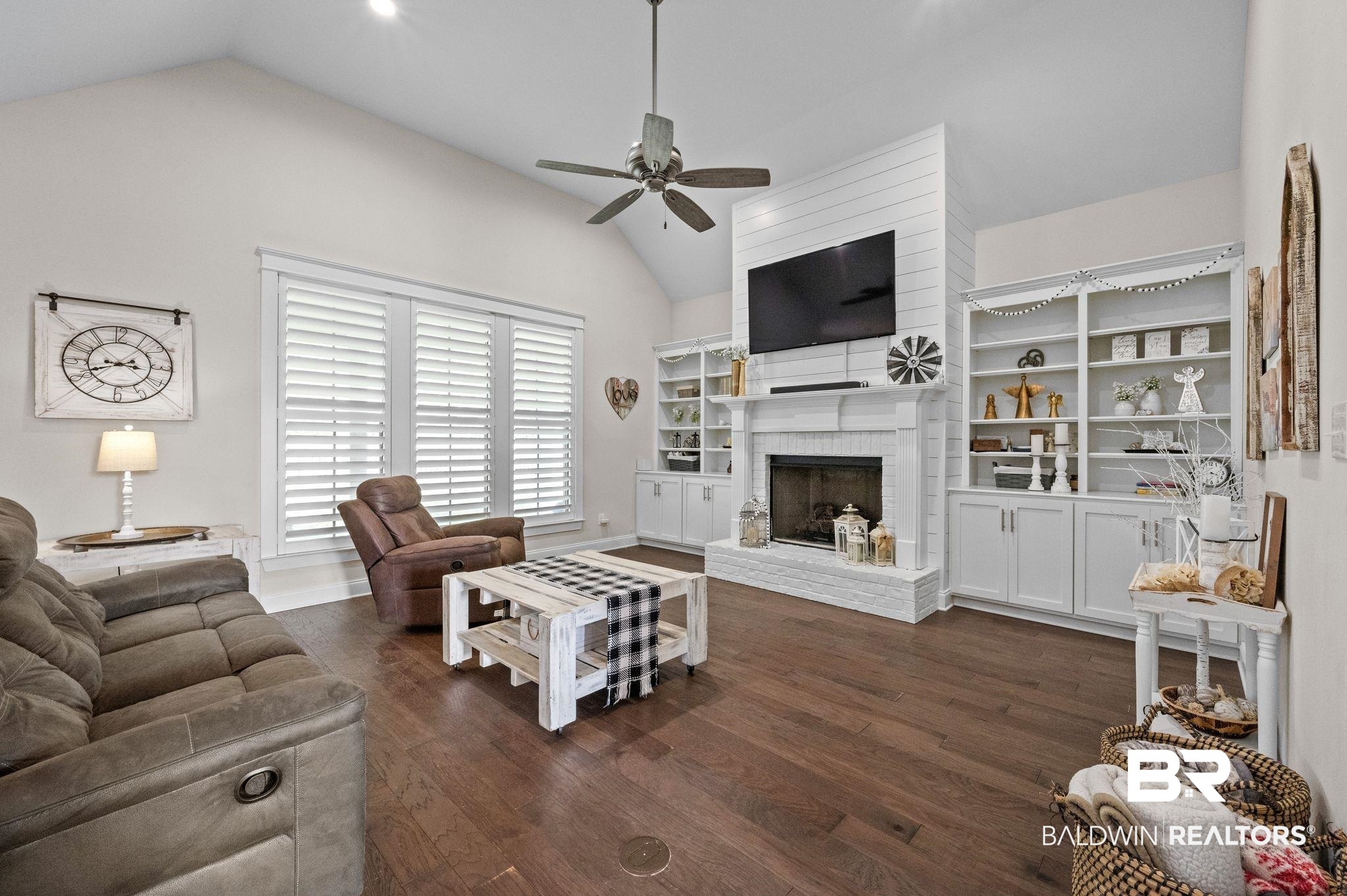 32194 Badger Court Daphne, AL 36527 - Photo 8 of 49 Living room with dark wood finished floors, a fireplace, vaulted ceiling, recessed lighting, and ceiling fan