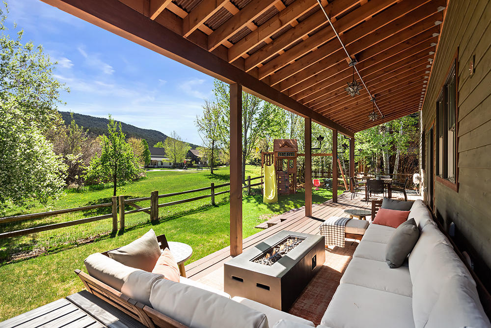 334 Sopris Circle Basalt, CO 81621 - Photo 29 of 34 a view of a patio with couches chairs dining table and chairs with wooden floor