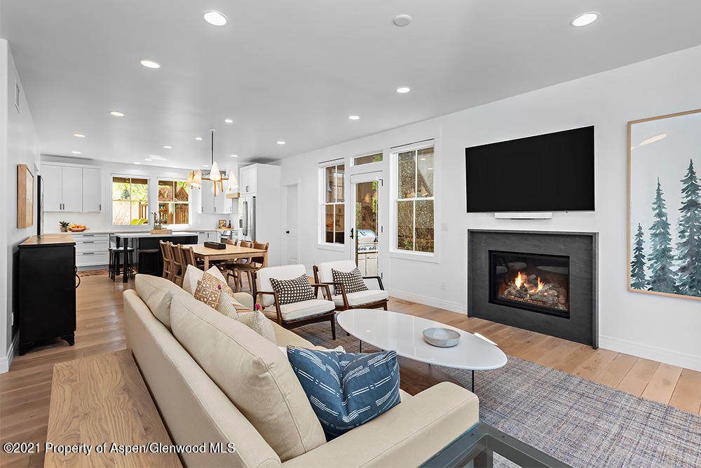 334 Sopris Circle Basalt, CO 81621 - Photo 3 of 34 a living room with furniture a flat screen tv and a fireplace