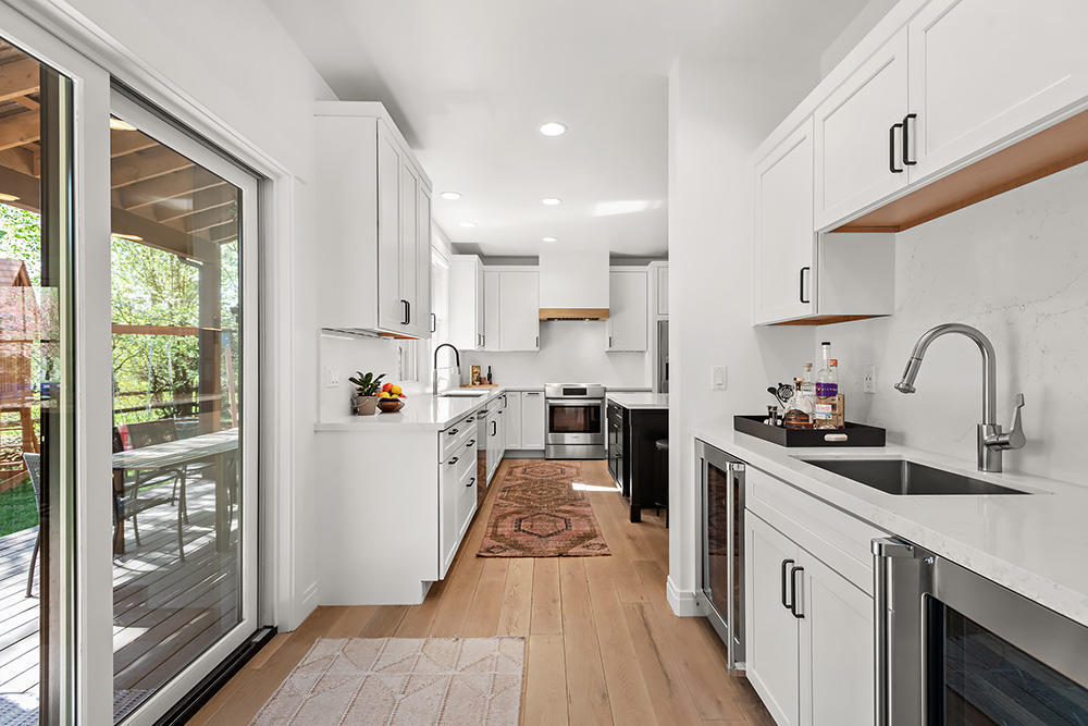 334 Sopris Circle Basalt, CO 81621 - Photo 7 of 34 a kitchen with white cabinets and appliances