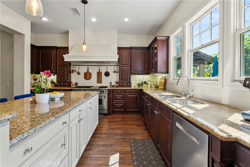 15 Pisano Street Ladera Ranch, CA 92694 - Photo 14 of 73 a large kitchen with stainless steel appliances granite countertop a sink stove and refrigerator