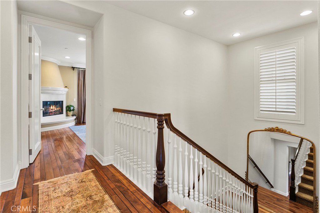 15 Pisano Street Ladera Ranch, CA 92694 - Photo 21 of 73 a view of a hallway with wooden floor and staircase