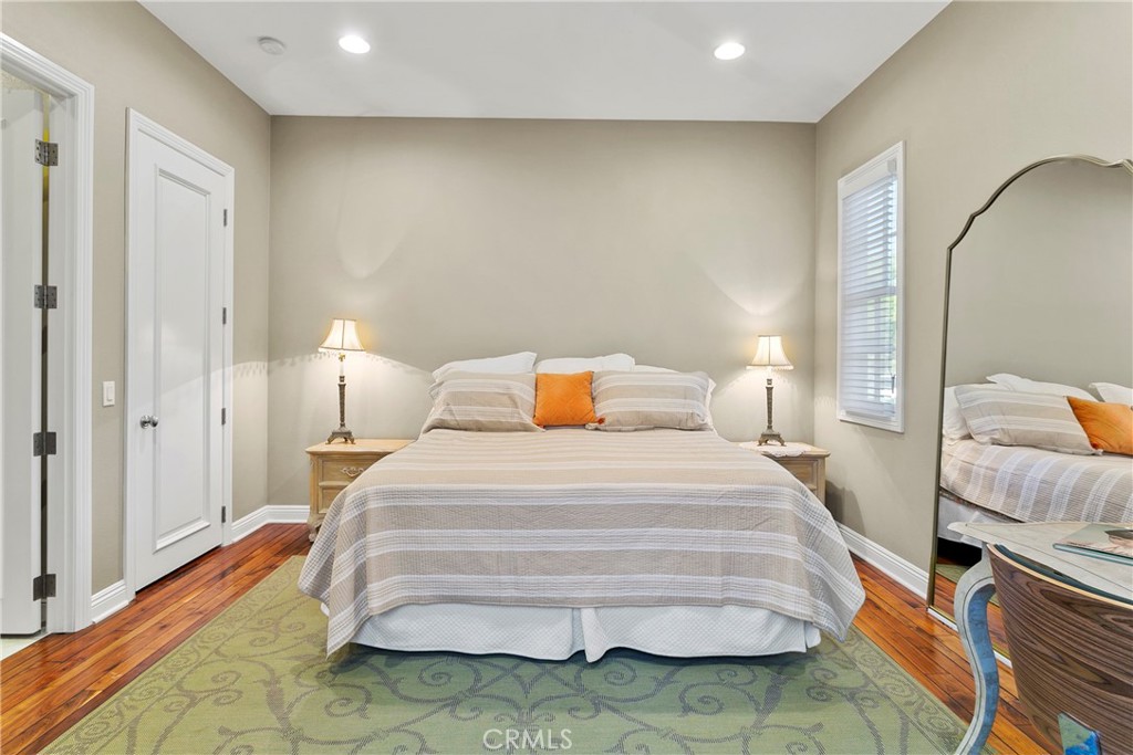 15 Pisano Street Ladera Ranch, CA 92694 - Photo 28 of 73 a bedroom with a bed and wooden floor