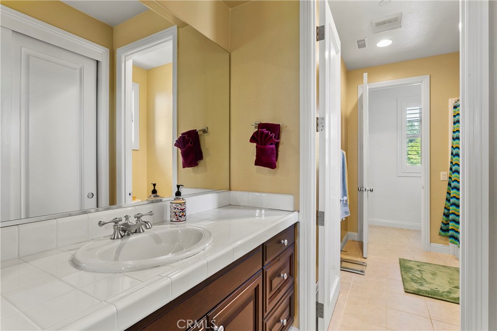 15 Pisano Street Ladera Ranch, CA 92694 - Photo 32 of 73 a bathroom with a sink and a mirror