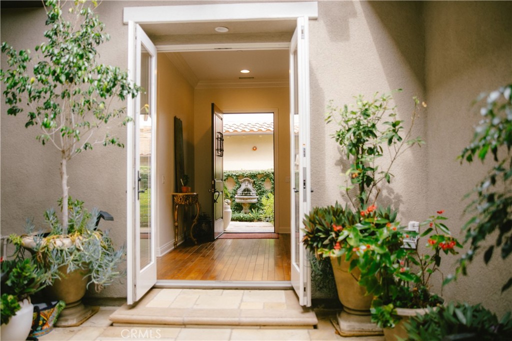 15 Pisano Street Ladera Ranch, CA 92694 - Photo 36 of 73 a potted plant sitting in front of a house with a garden