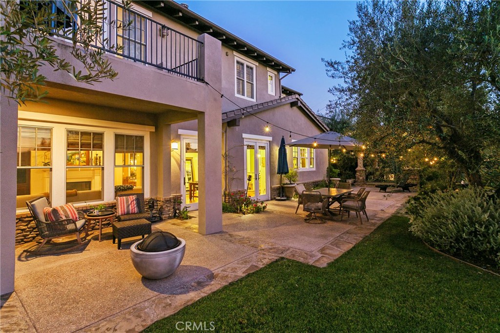15 Pisano Street Ladera Ranch, CA 92694 - Photo 39 of 73 a view of a patio with table and chairs potted plants and floor to ceiling window