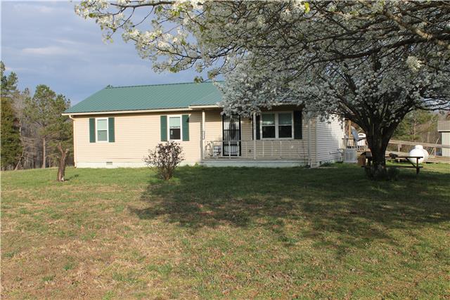 1463 Napier Road Hohenwald, TN 38462 - Photo 14 of 15 COVERED FRONT PORCH WITH BEAUTIFUL DOGWOOD TREE